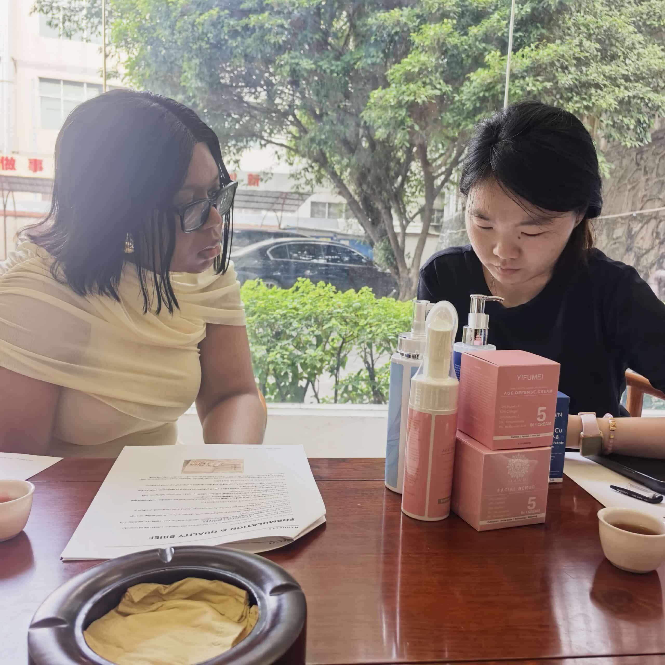 CrownDiaBio team discussing skincare products and formulation materials with visitors