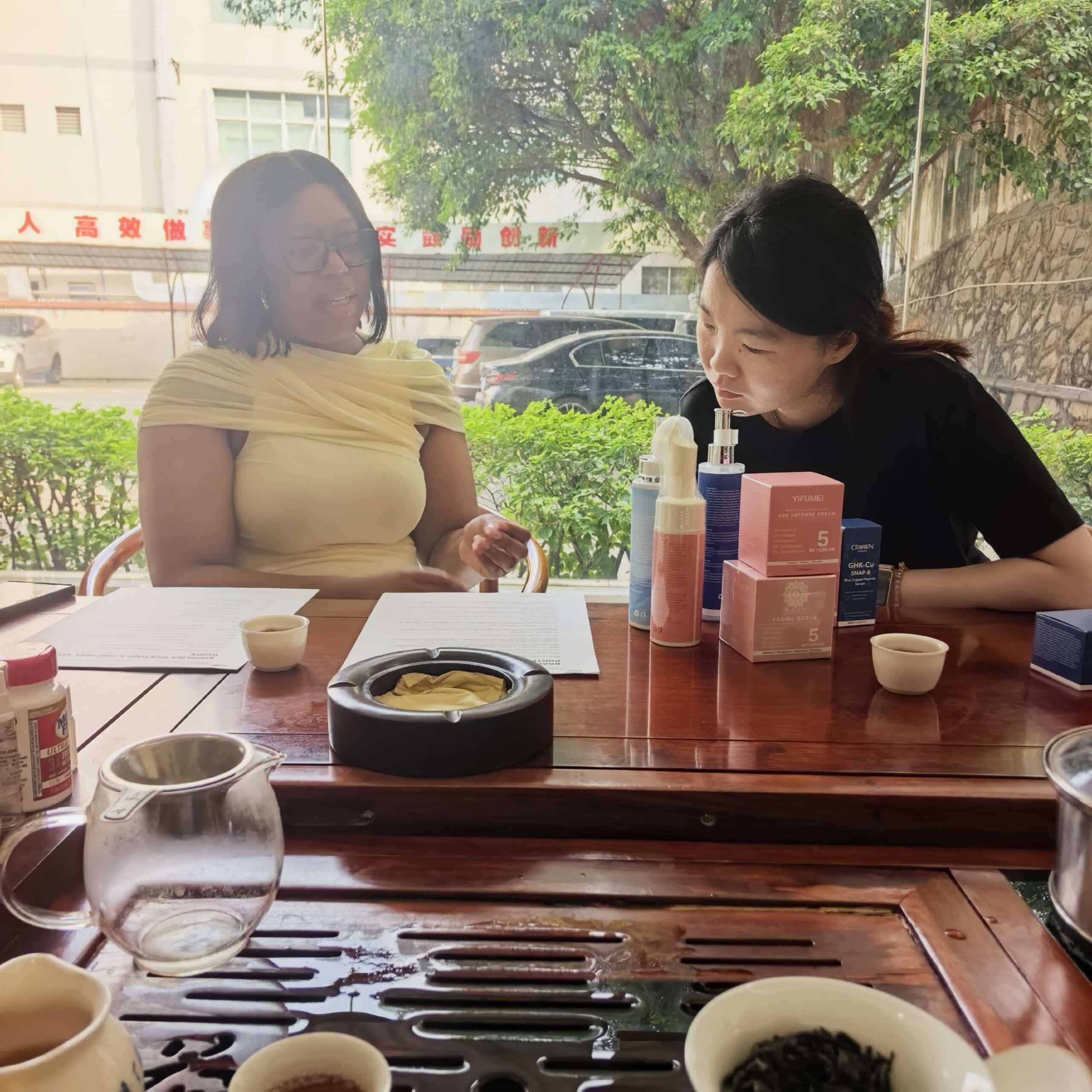 Visitors reviewing skincare products and project materials with the CrownDiaBio team